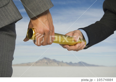 Businesspeople handing off baton in relay race, Salt Flats, Utah, United States 10574884
