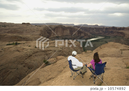 Couple in camping chairs over-looking canyon Couple in camping chairs over-looking canyon 10574892
