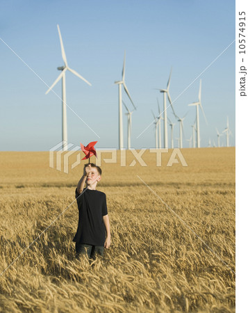 Boy holding pinwheel on wind farm 10574915