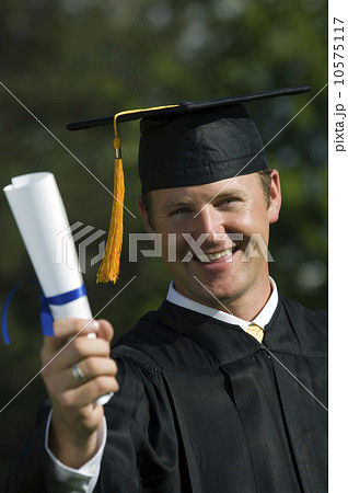 Male graduate holding diploma Male graduate holding diploma 10575117