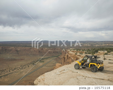 People in off-road vehicle at edge of cliff People in off-road vehicle at edge of cliff 10575118