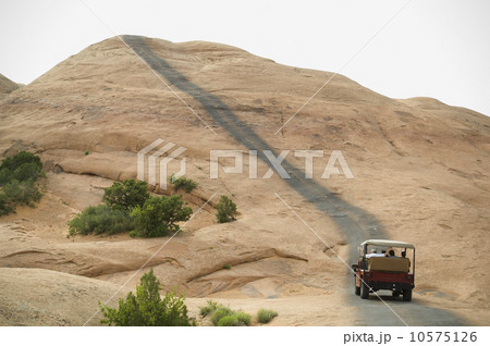 Off-road vehicle driving on rock formation Off-road vehicle driving on rock formation 10575126