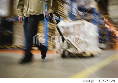 Warehouse worker pulling palette Warehouse worker pulling palette 10575129