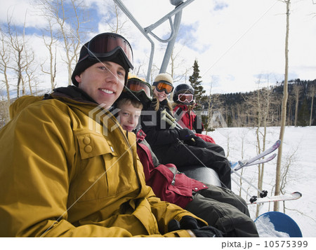 Family sitting on ski lift chair 10575399