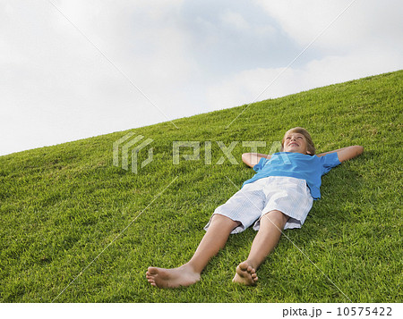 Boy resting on grass Boy resting on grass 10575422
