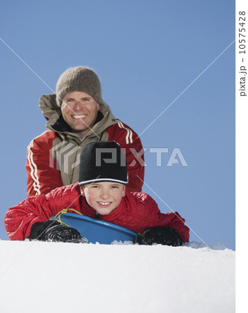 Father and son on sled in snow Father and son on sled in snow 10575428