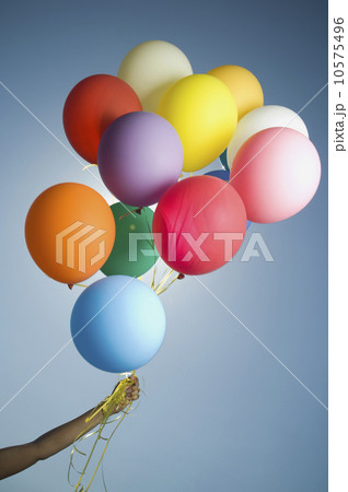 Woman holding bunch of balloons 10575496