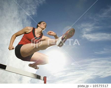 Female athlete jumping hurdle, Utah, United States Female athlete jumping hurdle, Utah, United States 10575517