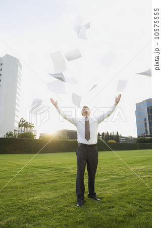 Businessman throwing papers in air Businessman throwing papers in air 10575555