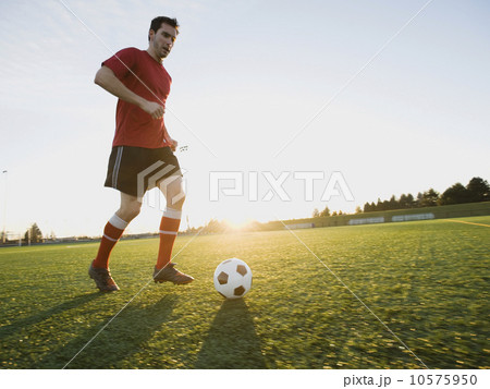 Soccer player dribbling ball Soccer player dribbling ball 10575950