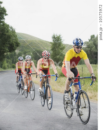 Cyclists in a row on country road Cyclists in a row on country road 10575972