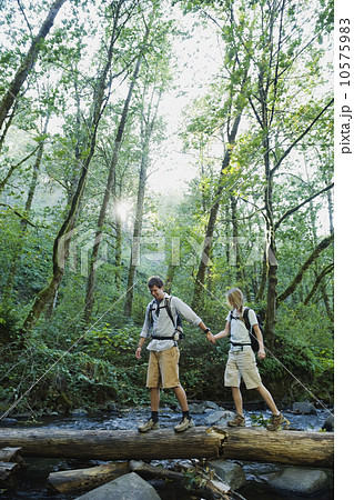 Hikers walking on log 10575983