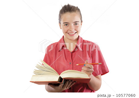teenage girl with book and pencil in here hands, smiling into ca 10577060