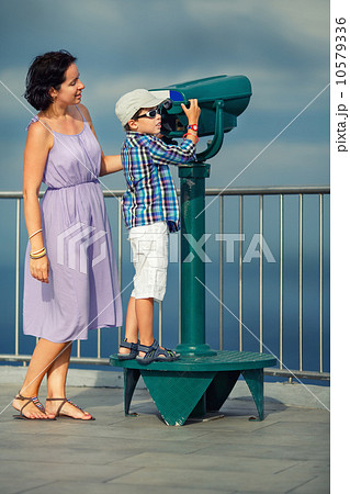 Mother and son looking through binoculars Mother and son looking through binoculars 10579336