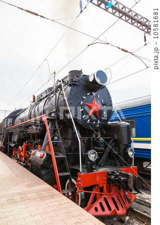 Old steam train is leaving a station 10581681