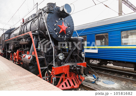 Old steam train is leaving a station 10581682