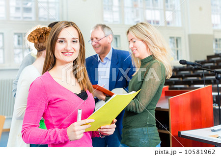 Students asking professor in college auditorium Students asking professor in college auditorium 10581962