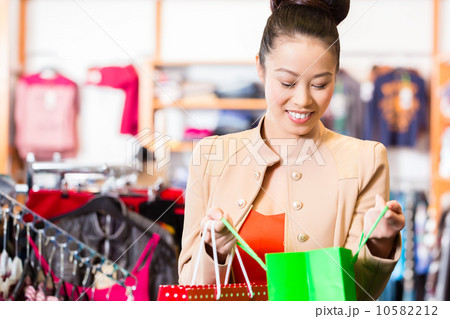 Asian Woman with shopping bags in shop 10582212