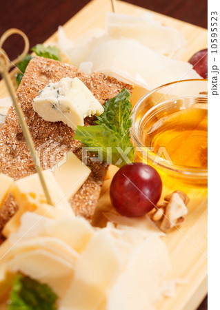 Cheese plate with grapes and honey Cheese plate with grapes and honey 10595523