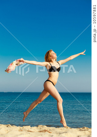 Summer vacation. Girl in bikini running on beach 10597881