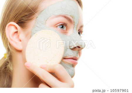 Skin care. Woman removing clay mud facial mask Skin care. Woman removing clay mud facial mask 10597901