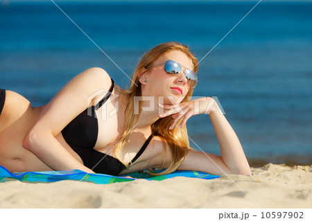 Summer vacation Girl in bikini sunbathing on beach 10597902