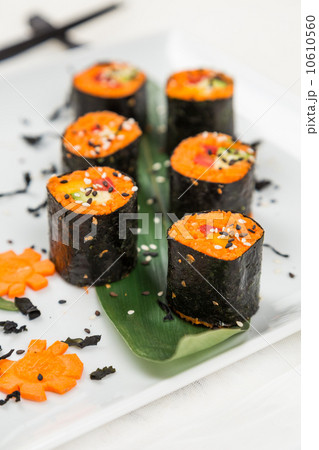 serving raw vegetarian rolls with carrot 10610560