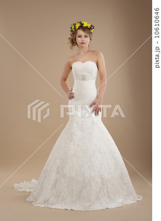Charming Woman in Bridal Dress with Wreath of Flowers 10610646