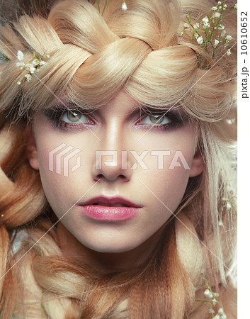 Closeup Portrait of Young Woman with Tress and Flowers 10610652