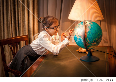 Little girl looking patiently at globe 10613933