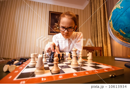 smart girl make move on chess board 10613934
