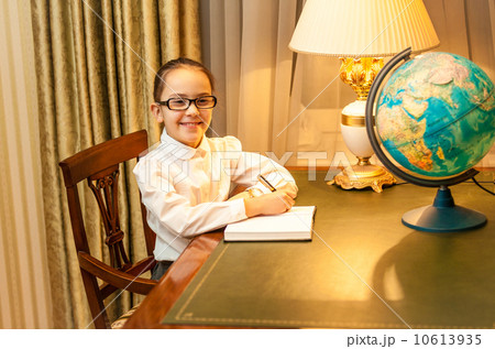 girl doing homework at classic desk 10613935