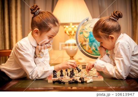 Girls in school uniform playing chess Girls in school uniform playing chess 10613947