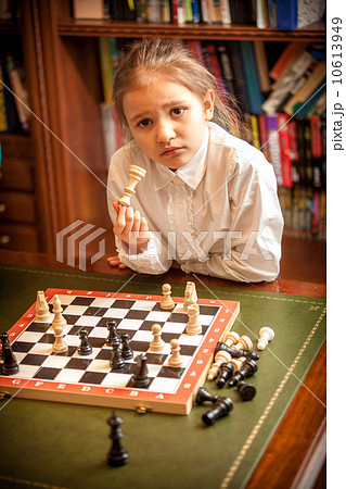 Girl thinking on move at chess 10613949