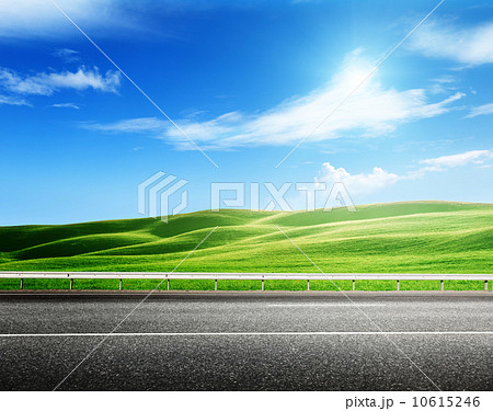 asphalt road and perfect green field asphalt road and perfect green field 10615246