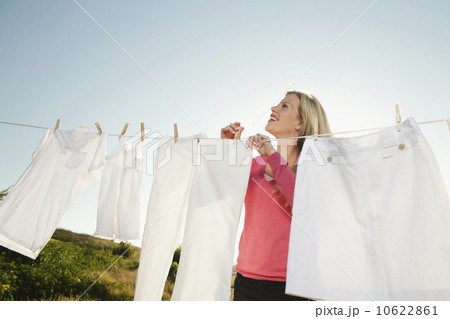 Woman hanging laundry on clothesline  10622861