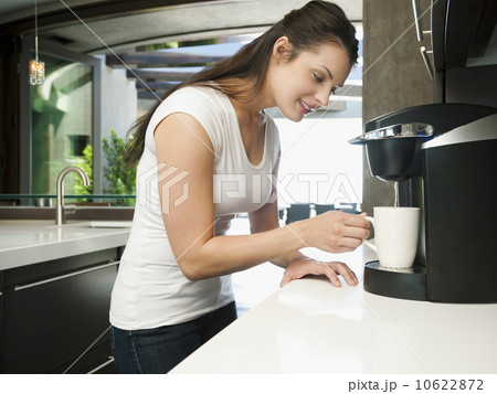 Young woman making morning coffee Young woman making morning coffee 10622872