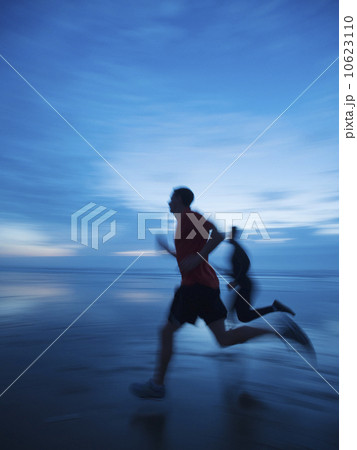 Man running along beach 10623110