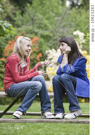 Girls talking in park Girls talking in park 10623265