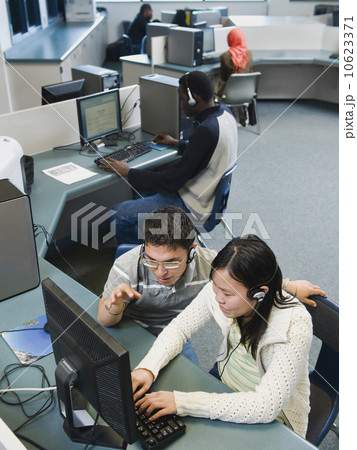 Adult students working on computers at a learning center 10623371