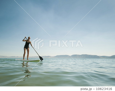 Young woman standing on paddleboard 10623416