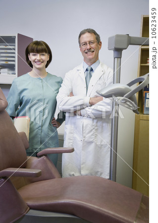 Dentist and dental hygienist in office 10623459
