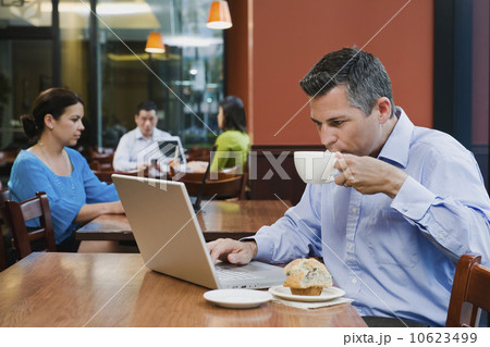Man working on laptop in restaurant Man working on laptop in restaurant 10623499