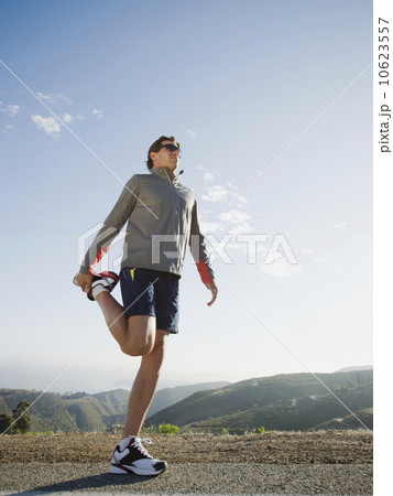 Runner stretching on the side of the road 10623557