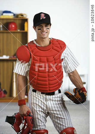 Portrait of baseball catcher in locker room Portrait of baseball catcher in locker room 10623646