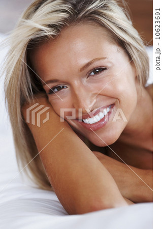 Blonde woman lying on bed 10623691