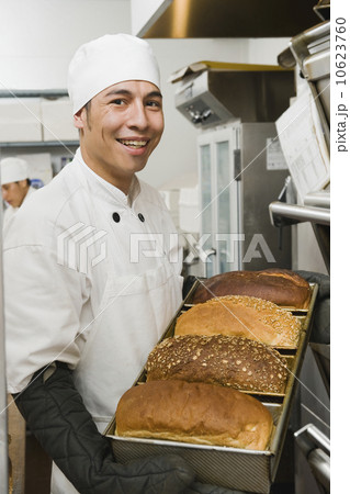 Chef holding tray of freshly baked bread Chef holding tray of freshly baked bread 10623760