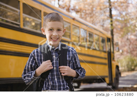 Boy with backpack in front of school bus Boy with backpack in front of school bus 10623880