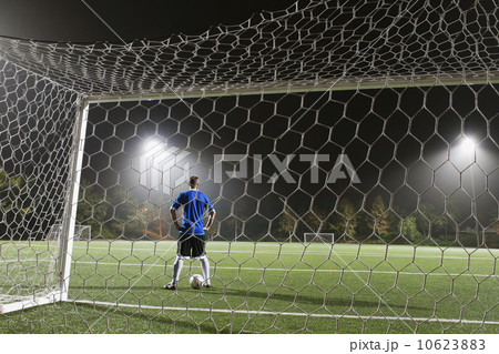 USA, California, Ladera Ranch, goalie on illuminated soccer field at night 10623883