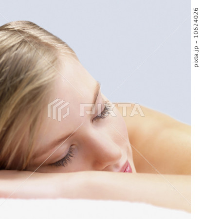 Young woman lying down in massage table Young woman lying down in massage table 10624026